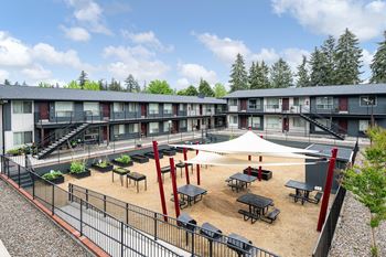 Community area with bbqs, picnic area, garden beds, bean bag toss, and boccie ball